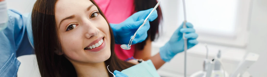 A woman smiling during a dental checkup.