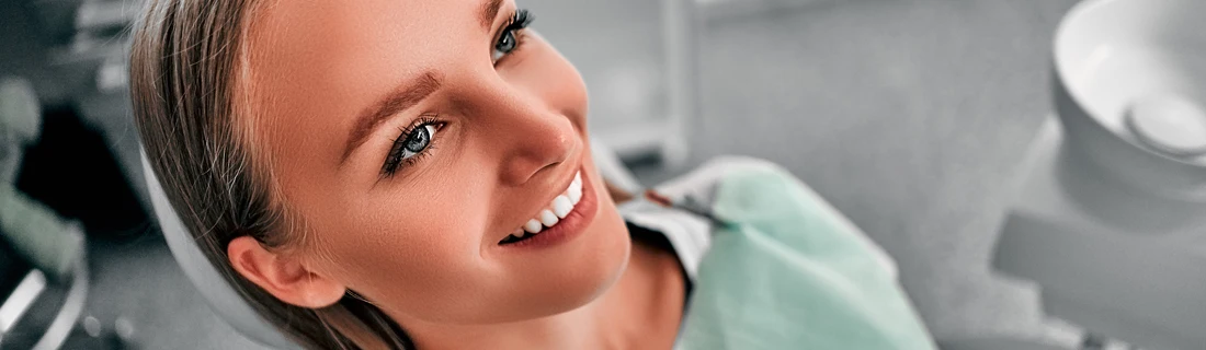 A woman smiling in a dental chair.