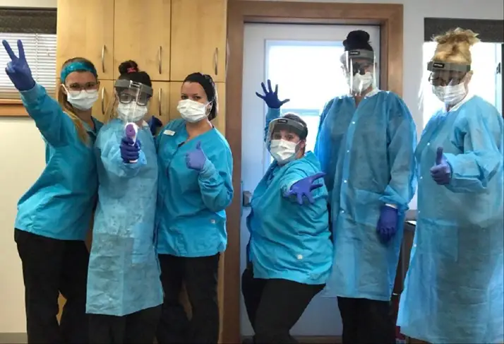 A team of 6 dressed in safety clothes.